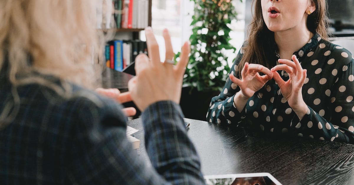 how do you make commands not show up on the chat - Young female friends communicating using sign language in library