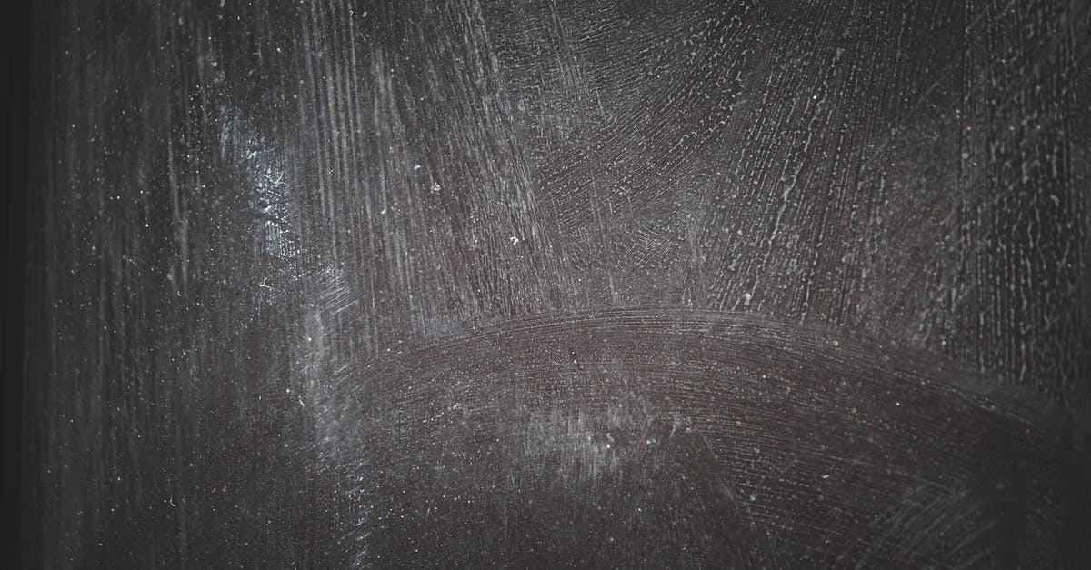 How do you mark components and what effect does it have? - Smeared white paint marks on rough dark surface with stains as abstract background