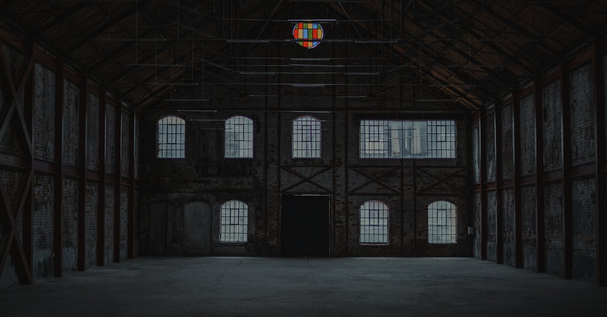 How do you max out damage output for the climax hex in dark souls 2 - Interior of spacious empty desolated building with concrete floor and shabby walls with large windows and black door