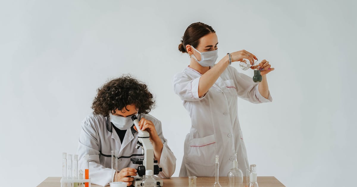 How do you not smash the laboratory wall? [duplicate] - A Man and Woman Wearing Face Mask Inside the Laboratory