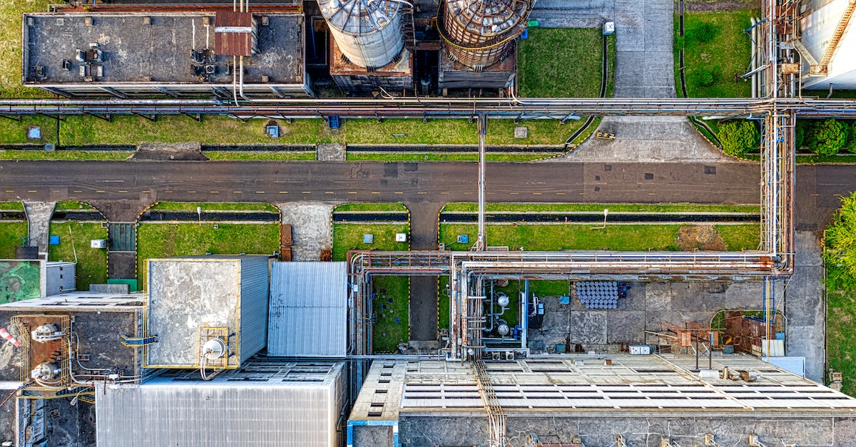 How do you produce iron? - Aerial view of old factory with tanks and facility for industrial production located along road