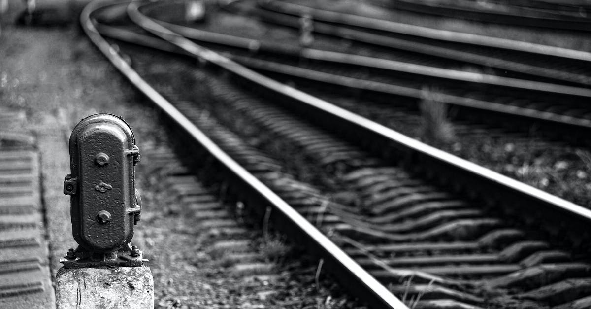 How do you remove a station from a line? - From above black and white of traffic light above pebble surface near shining railway with wooden planks