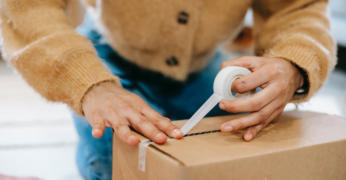How do you send your followers to their original homes after sending them to a settlement? - Crop unrecognizable woman sealing carton parcel with tape