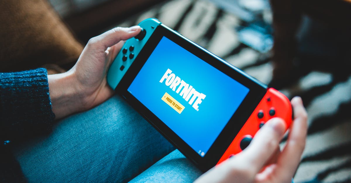 How do you turn on your Mic on Fortnite for Nintendo Switch? - A Person Holding a Game Console