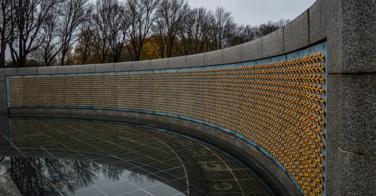 How do you Unlock General Grievous in Lego Star Wars III? - Golden stars on Freedom Wall at World War II Memorial located in in National Mall in Washington DC against gloomy sky