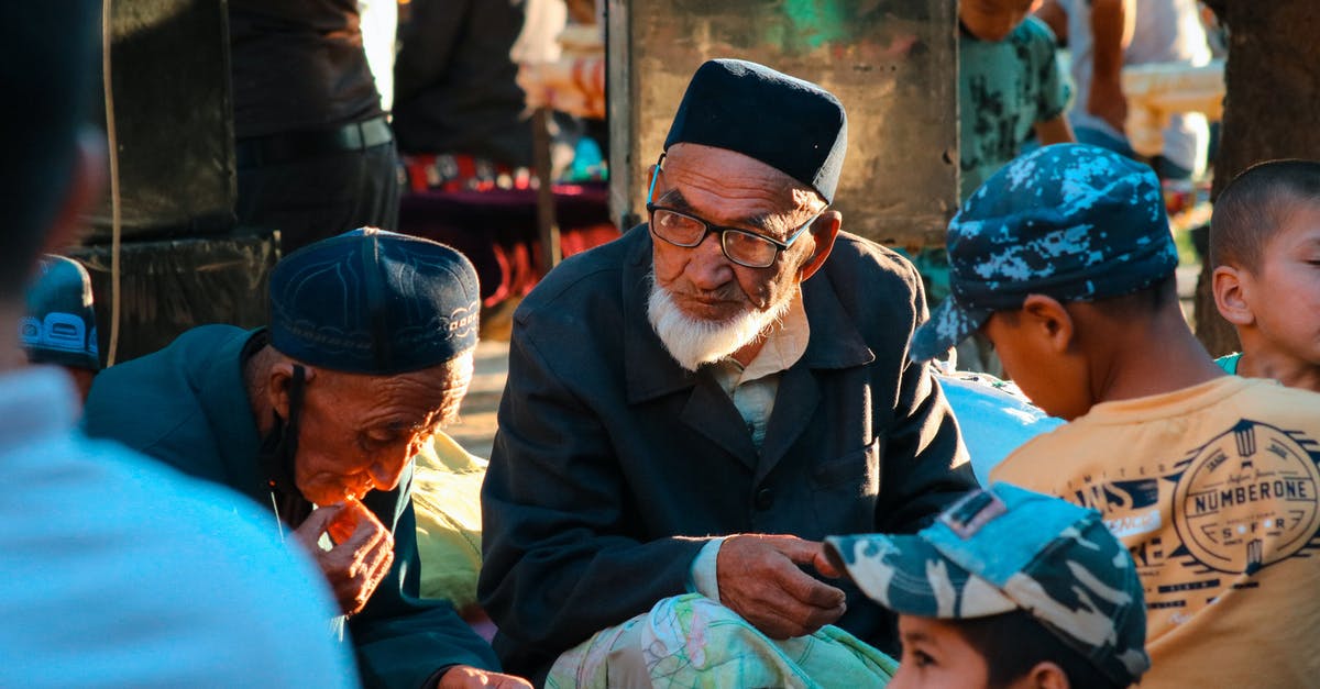 How do you unlock level caps of Palicos and Prowlers? - Man in Black Suit Jacket Sitting Beside Woman in Green Hijab