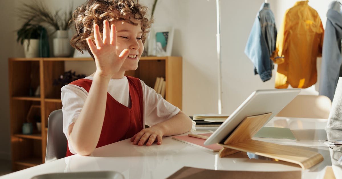 How do you use ranged weapons on the ipad version of Brogue - Photo of Child Smiling While Using Tablet Computer