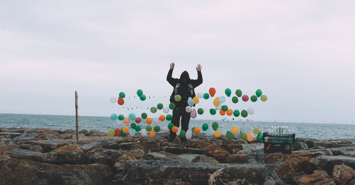 How do you use Rope Darts on PC? - Man offering darts with balloons on coast of sea How do you use Rope Darts on PC? - Man offering darts with balloons on coast of sea