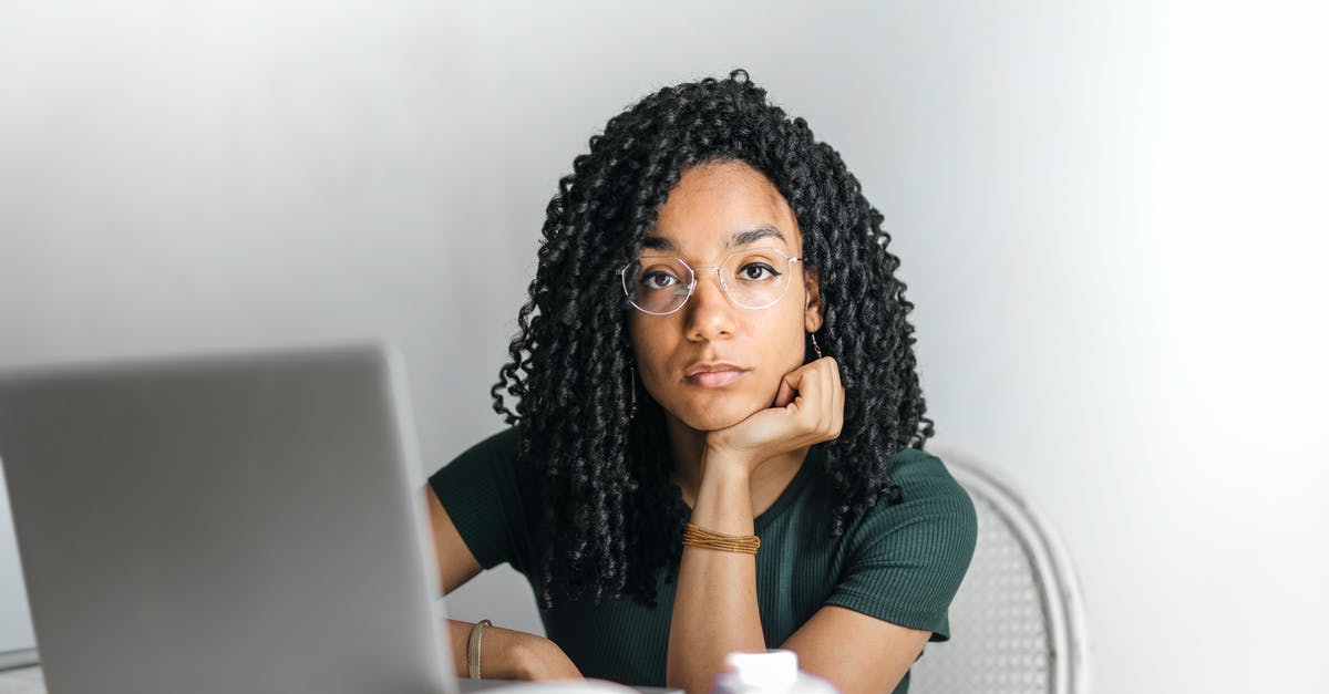 How do you use the X potion? - Serious ethnic young woman using laptop at home