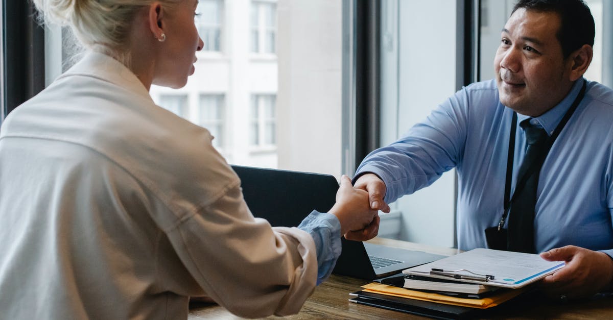 How does Armamentarium interact with Surplus? - Ethnic businessman shaking hand of applicant in office