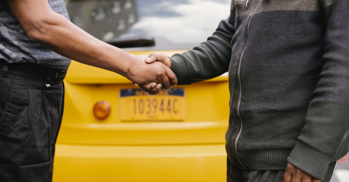 How does Armamentarium interact with Surplus? - Side view of crop ethnic anonymous males shaking hands while meeting each other on street