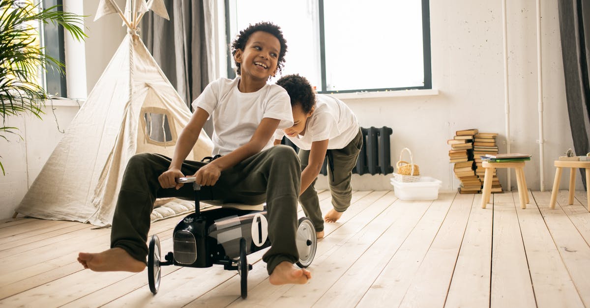 How does auto play work? - Happy barefoot African American brothers in casual wear riding toy car while playing together in light room with blanket fort How does auto play work? - Happy barefoot African American brothers in casual wear riding toy car while playing together in light room with blanket fort