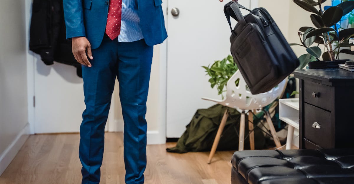 How does boosted exp. work? - Man in Blue Suit Jacket and Blue Pants Holding Black Leather Sling Bag