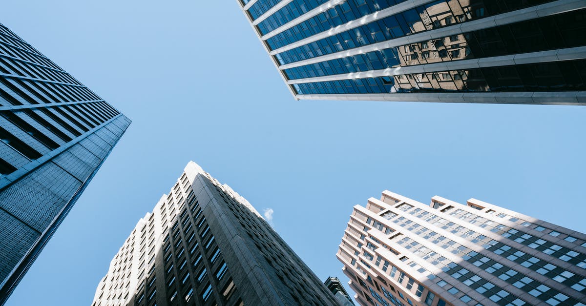 How does cornering work? - Low angle of high business center with glass mirrored windows near concrete office towers in downtown
