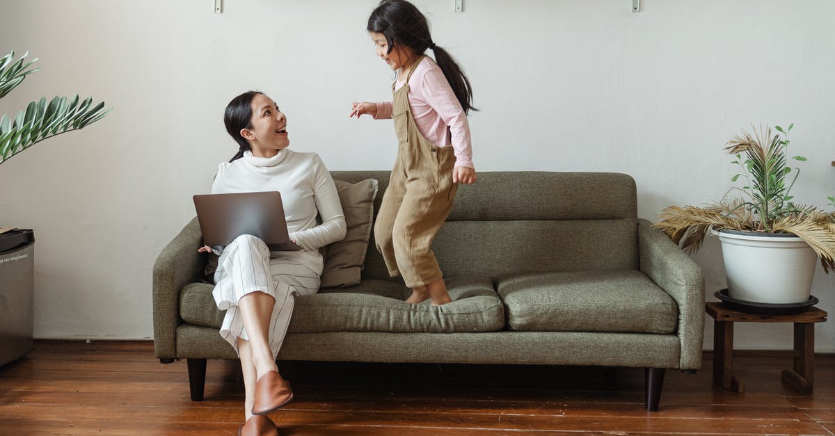 How does Crouch jump actually work? - Happy mother with laptop talking to little daughter on couch How does Crouch jump actually work? - Happy mother with laptop talking to little daughter on couch