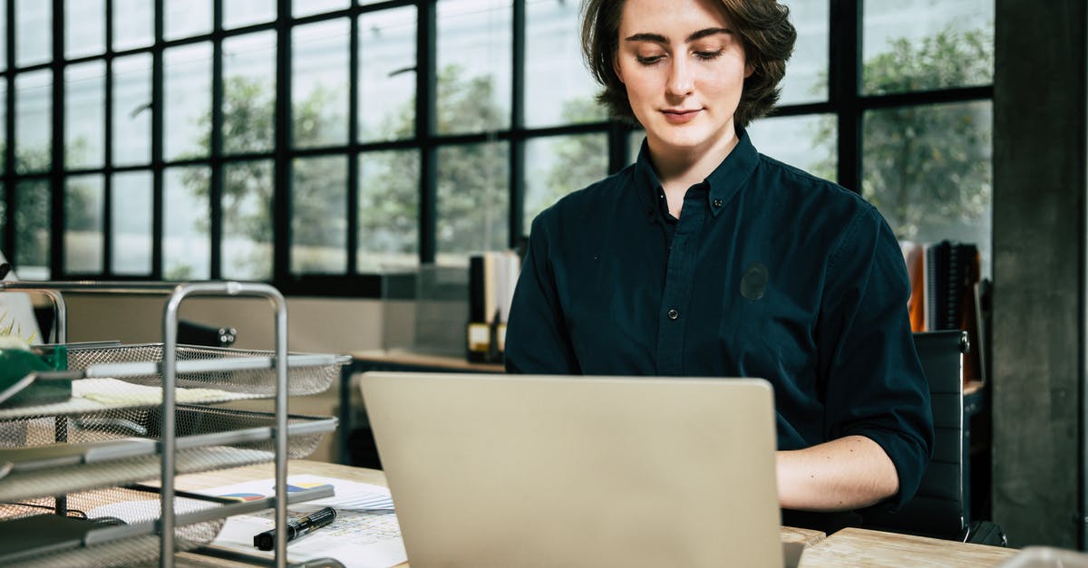 How does DLC work with Xbox One backwards compatibility? - young business woman working laptop while consulting some invoices and documents in office