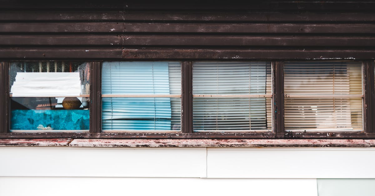 How does elemental damage in weapons work in Diablo II? - Exterior of aged shabby wooden house with glass windows in city street at daylight