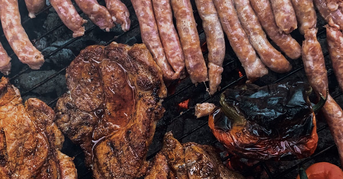 How does fire from Starlight Dragonling work? - From above yummy steaks and meat sausages roasting on grill grid near organic capsicum during picnic