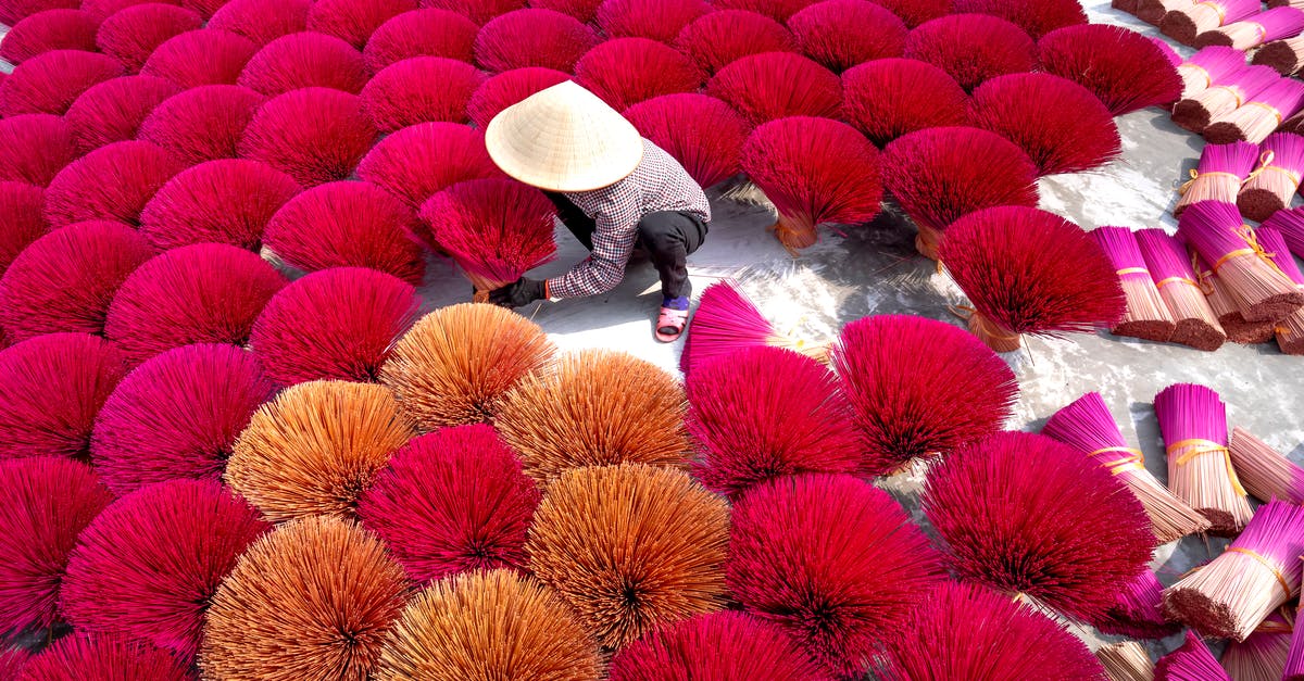 How does Incense work? - From above of man in white Asian conical hat preparing colorful sticks for producing aromatic sticks in Vietnam incense village How does Incense work? - From above of man in white Asian conical hat preparing colorful sticks for producing aromatic sticks in Vietnam incense village