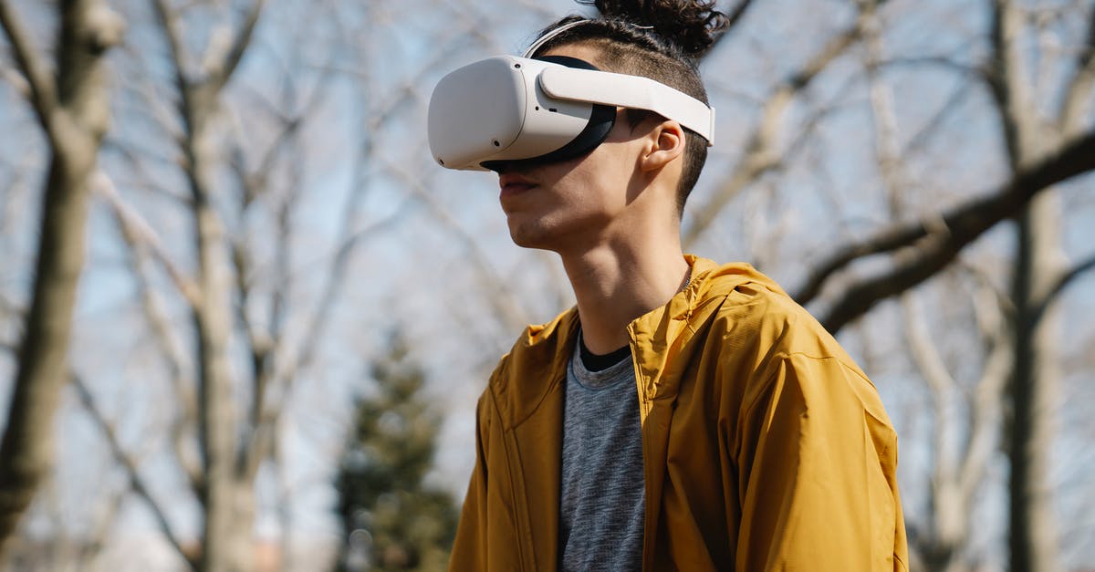 How does KSP simulate objects out of focus? - Young man in jacket looking through VR headset on blurred background of bare trees in sunny park How does KSP simulate objects out of focus? - Young man in jacket looking through VR headset on blurred background of bare trees in sunny park