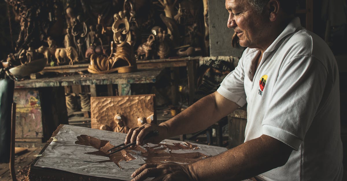 How Does Making a Skill Legendary Affect Spells? - Man in White Polo Shirt Working on Wooden Sculpture
