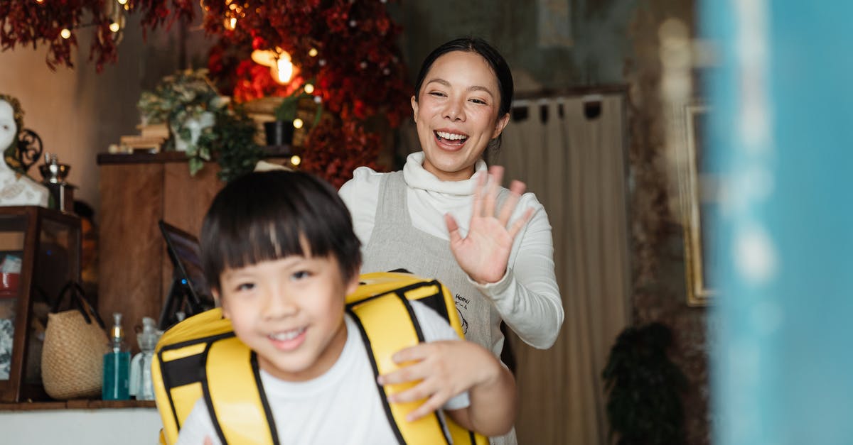 How does Mother Base staff morale work? - Cheerful ethnic mother saying goodbye to son with food backpack