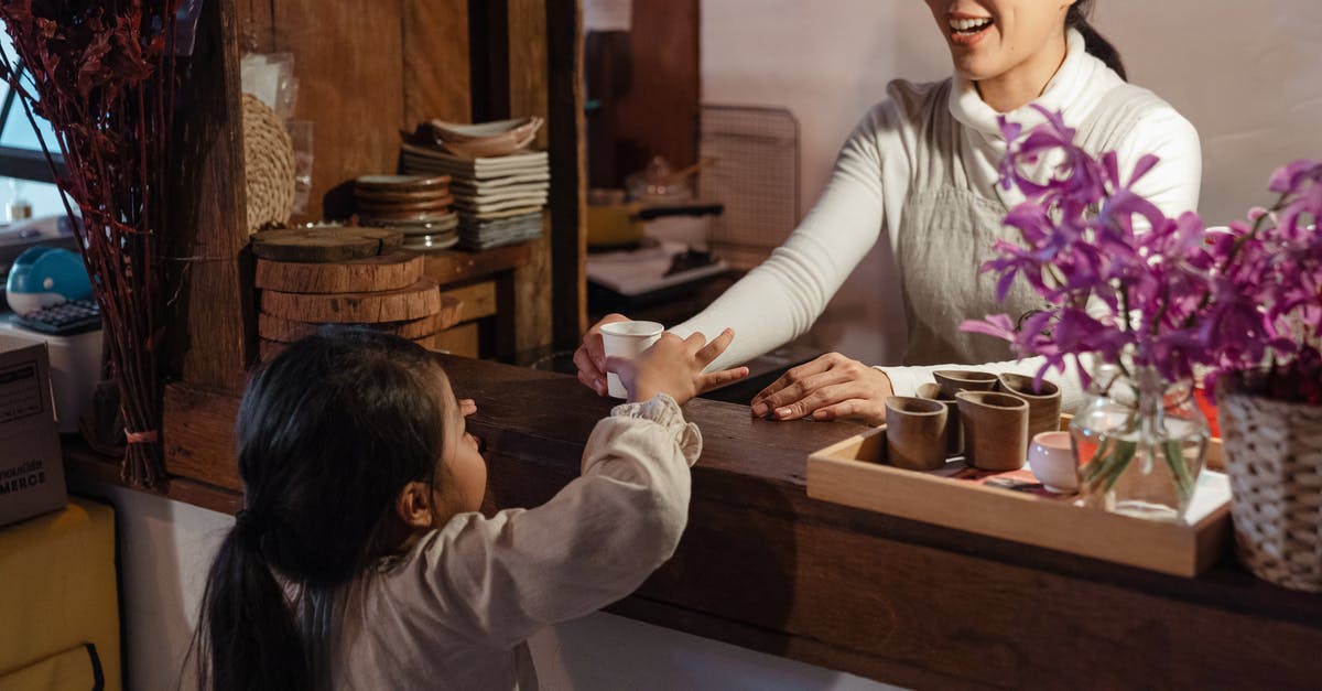 How does Mother Base staff morale work? - Crop ethnic mother serving little girl glass of refreshing drink