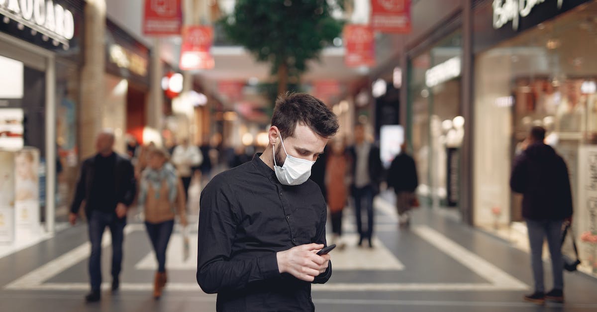 How does one use @e data on a custom named snowball - Young man in disposable mask using smartphone in middle of shopping center How does one use @e data on a custom named snowball - Young man in disposable mask using smartphone in middle of shopping center