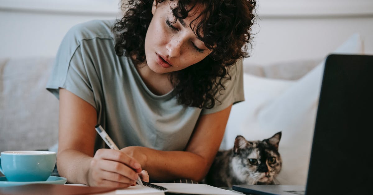 How does pet insurance work for leagues? - Focused young female student doing homework using netbook sitting near cute cat How does pet insurance work for leagues? - Focused young female student doing homework using netbook sitting near cute cat