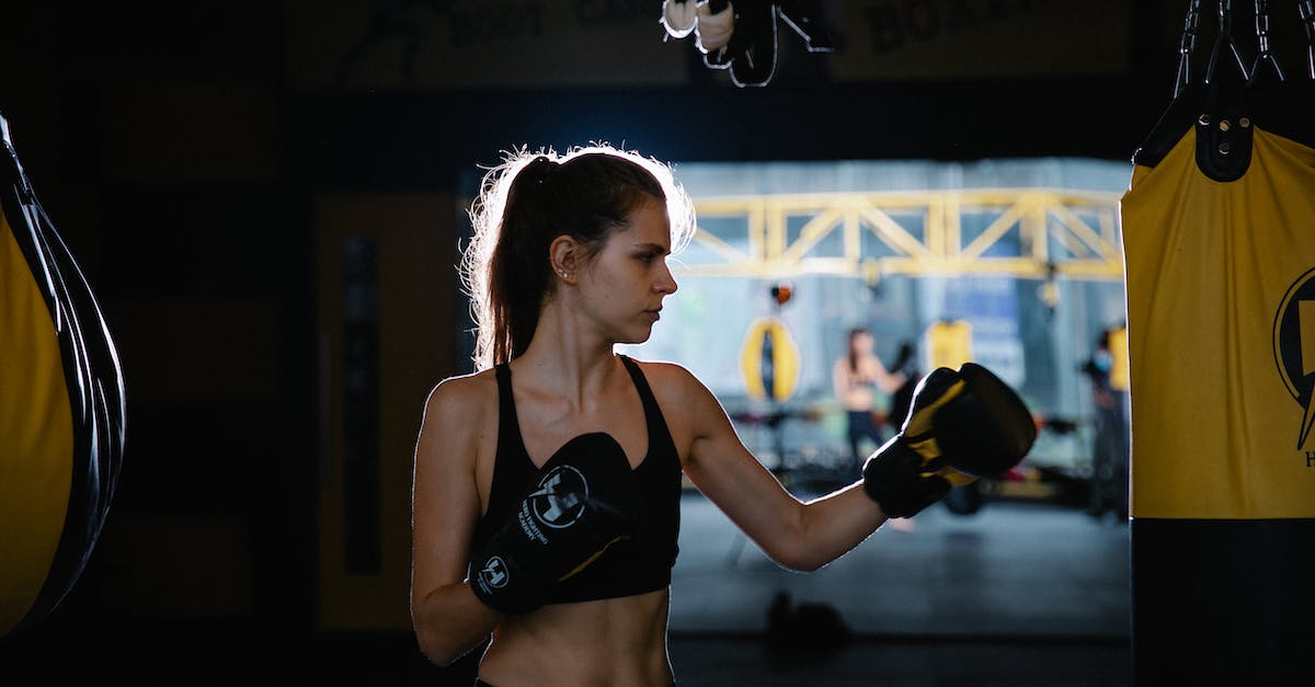 How does Power Stance work? - Concentrated fir sportswoman practicing boxing punches in gym How does Power Stance work? - Concentrated fir sportswoman practicing boxing punches in gym