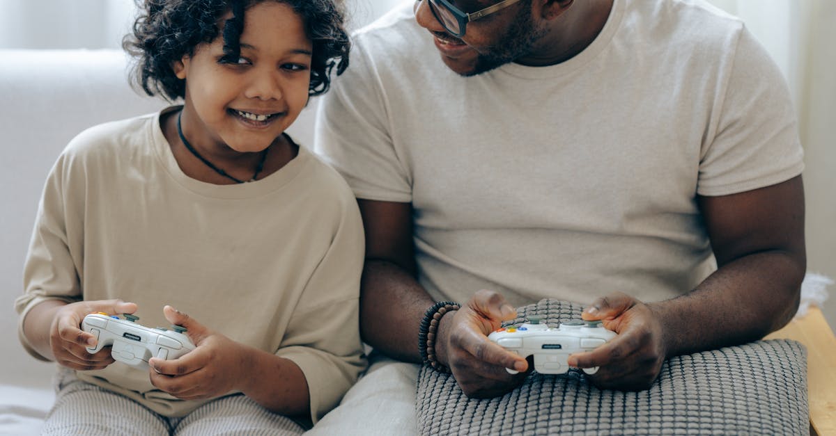 How does Rockstar expire your online character/save game? (Are they in control?) - Happy black father and daughter playing video game with controllers