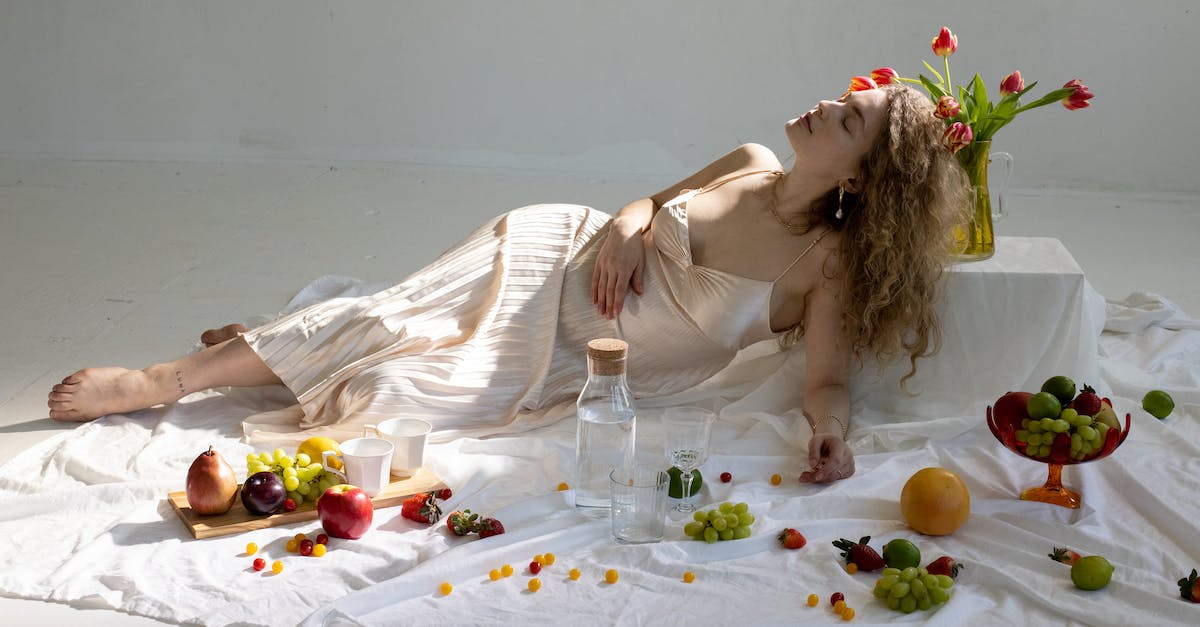 How does Serene Grace work with Razor Fang? - Peaceful young elegant woman lying on floor near fruits scattered on white cloth How does Serene Grace work with Razor Fang? - Peaceful young elegant woman lying on floor near fruits scattered on white cloth