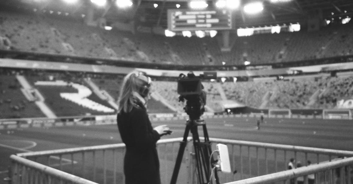 How does the Arena work? - Female camera operator working at stadium How does the Arena work? - Female camera operator working at stadium