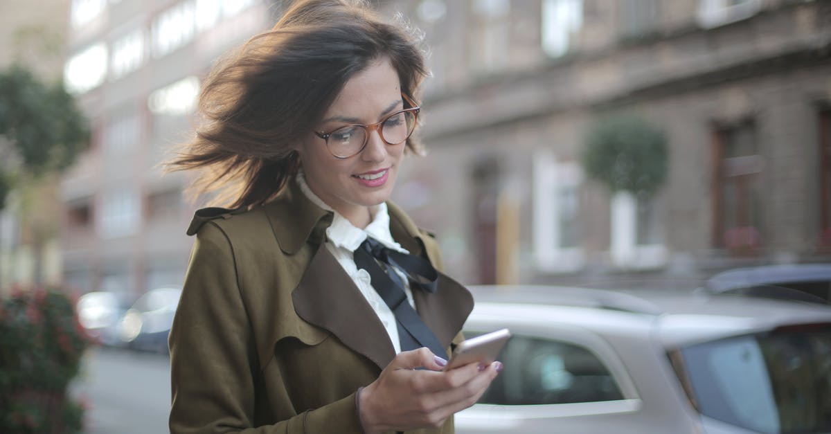 How does the Auto selection work? - Stylish adult female using smartphone on street