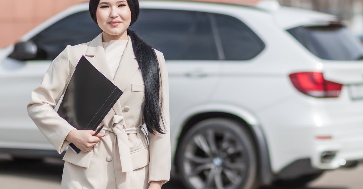 How does the Auto selection work? - Woman in Beige Corporate Clothes Holding Black Folder 