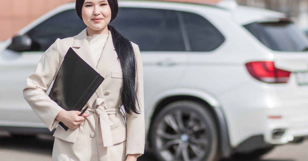 How does the Auto selection work? - Woman in Beige Corporate Clothes Holding Black Folder How does the Auto selection work? - Woman in Beige Corporate Clothes Holding Black Folder