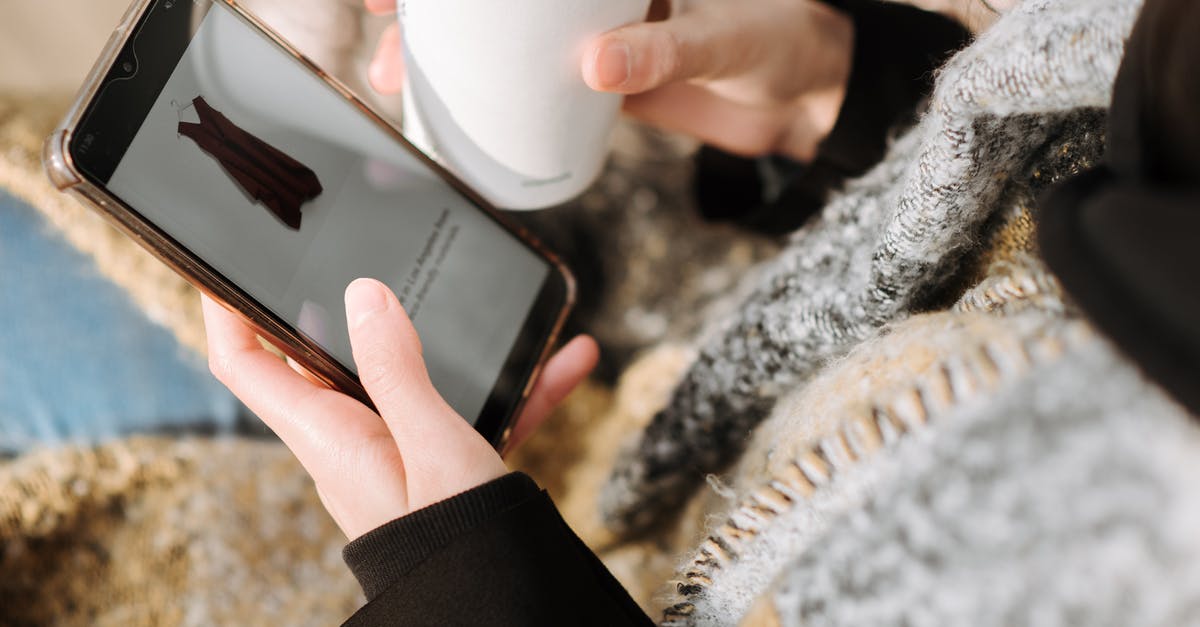 How does the Digi-Clone choose what gun to use? - From above of crop anonymous female purchaser with takeaway hot drink choosing dress on cellphone screen during online shopping