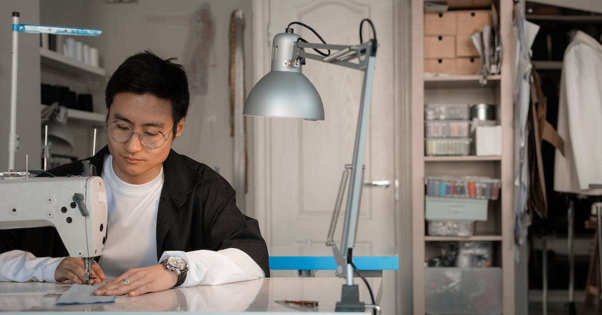 How does the Huntress's Long Range skill work? - Man Sitting at Table with Sawing Machine