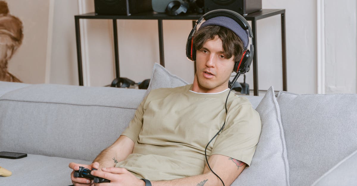 How does the PS4 internal fans work to cool down the PS4 after closing a game? - Close-Up Shot of a Man Playing a Video Game