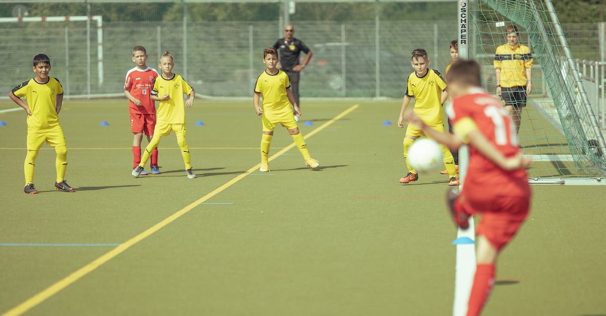 How does the stamina store work on Flick Kick Football Legends? - Dedicated teenage boys in activewear playing football together on field of outdoor stadium on sunny summer day