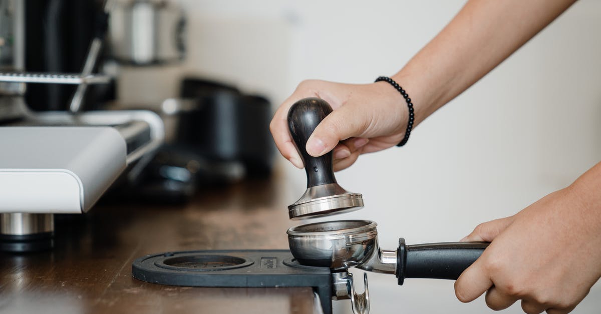 How does the swtor subscription work in steam? - Crop anonymous barista pressing aromatic coffee beans into filter block by using tamper while standing in light kitchen nearby professional brewing machine