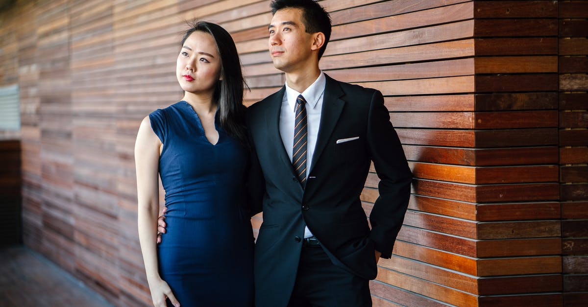 How does the WAR suit ability Shield Wall work? - Models posing. an and Woman Standing Next to Each Other Looking Upward