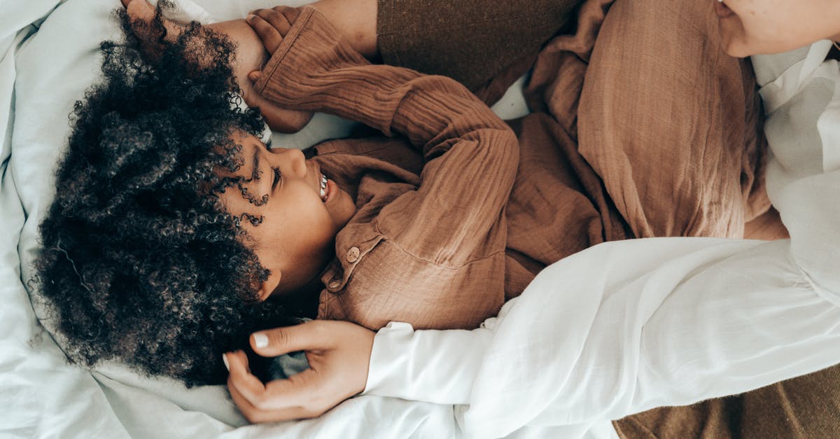 How does Vivi differ from other Black Mages? - Happy ethnic kid playing with mom on bed How does Vivi differ from other Black Mages? - Happy ethnic kid playing with mom on bed