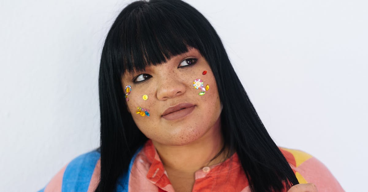 How far away can you be to play MCPE with someone? - Young woman with fun makeup touching hair