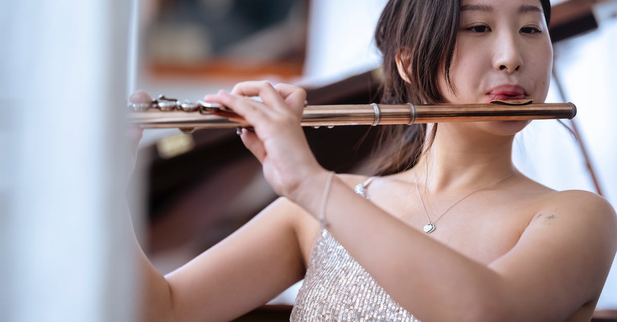 How far away do I need to be away from guards and sound bugs to avoid being heard? - Young Asian female musician playing flute How far away do I need to be away from guards and sound bugs to avoid being heard? - Young Asian female musician playing flute