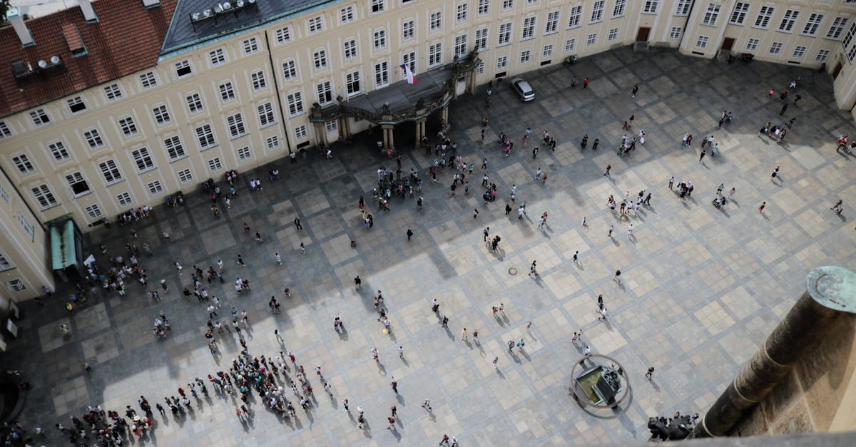 How far do chests render from? - From above of travelers on square in front of aged vintage panoramic exploring sightseeing and studying place in daylight