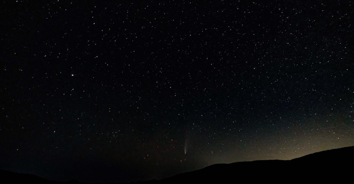 How far does the range of magic go? - Low angle of spectacular night sky with luminous stars and falling comet over dark mountainous terrain How far does the range of magic go? - Low angle of spectacular night sky with luminous stars and falling comet over dark mountainous terrain