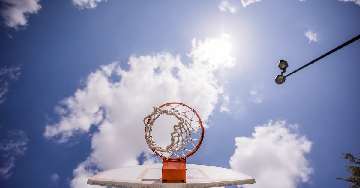 How high can a player go? - Basketball hoop hanging on backboard under sunshine How high can a player go? - Basketball hoop hanging on backboard under sunshine