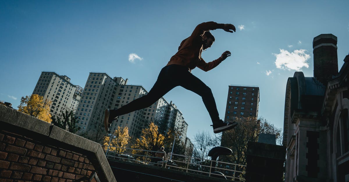 How high can I jump? - Energetic man jumping on street How high can I jump? - Energetic man jumping on street