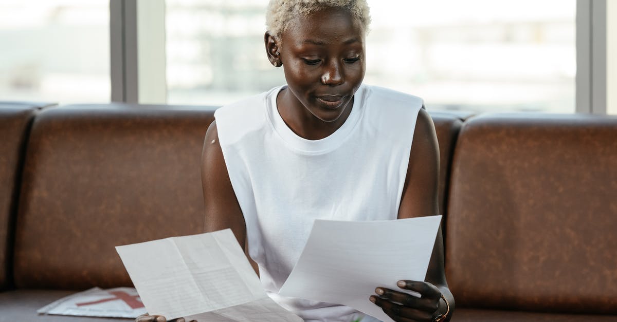 How important is proper execution of QTEs in Fractured But Whole? - Concentrated African American female comparing important papers of report on leather sofa in office